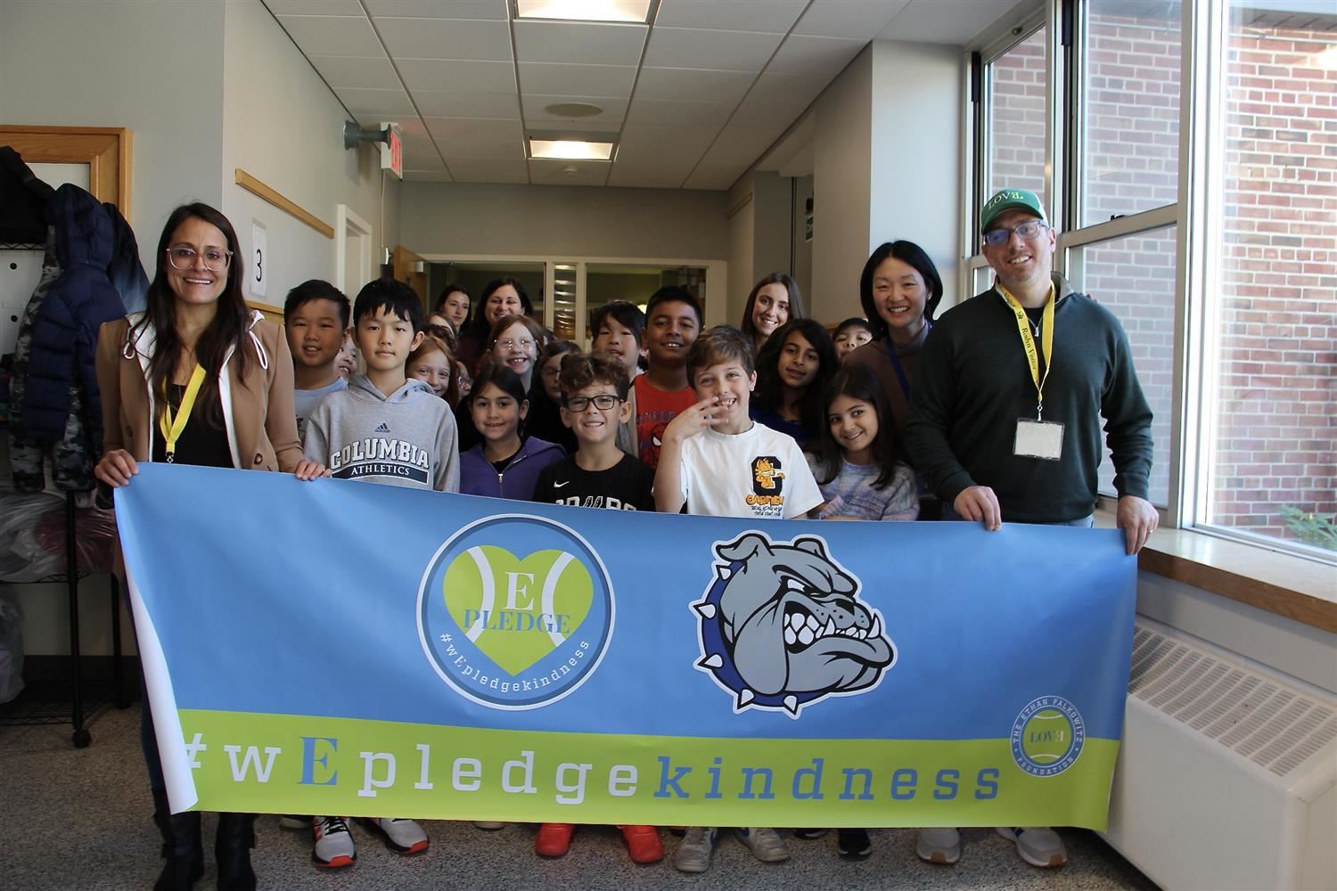  The Falkowitz with banner and students