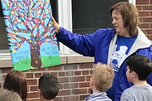 Regina Colardi, Heights School Principal, receives a tribute from students 